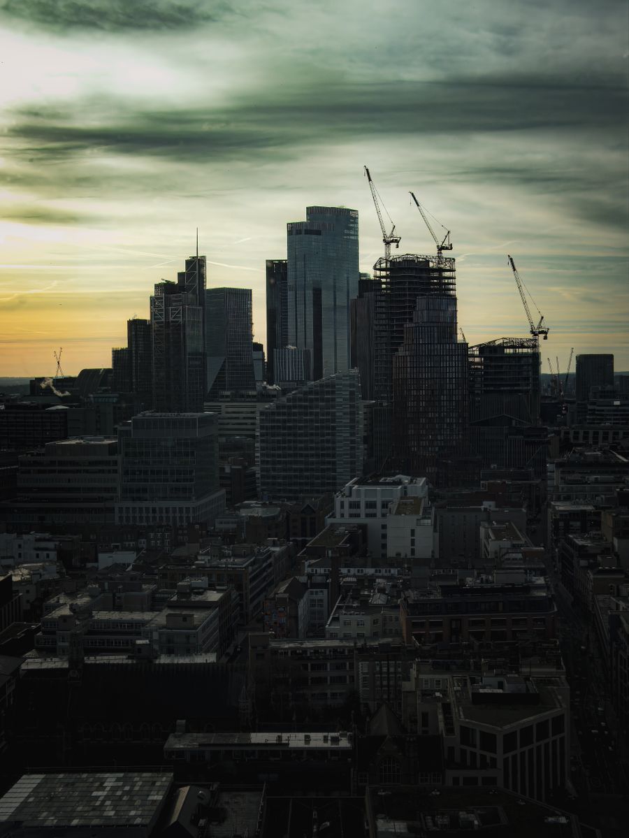Tower cranes over the London skyline at dusk